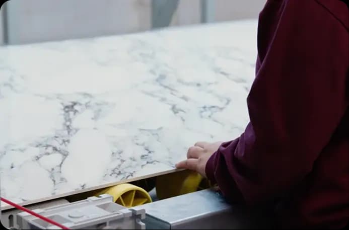 Stone craftsman inspecting a large slab